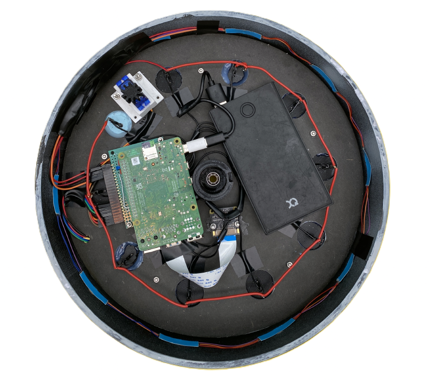 Underside of the rotating rack with its electronics exposed: Raspberry Pi 4, SG90 servo, BME680 sensor, perfboard with pull-down resistors, and the WS2812B LED strip wired to the slot positions.